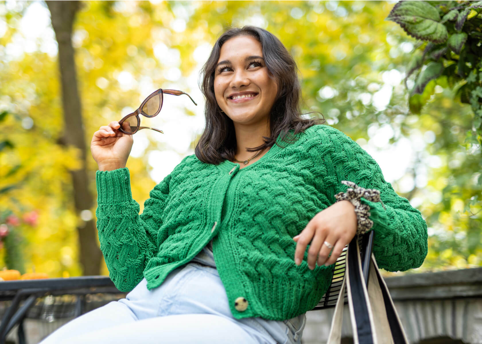 A women with an joyful expression on her face glad that she can earn reward points when shopping or selling at a Plato's Closet